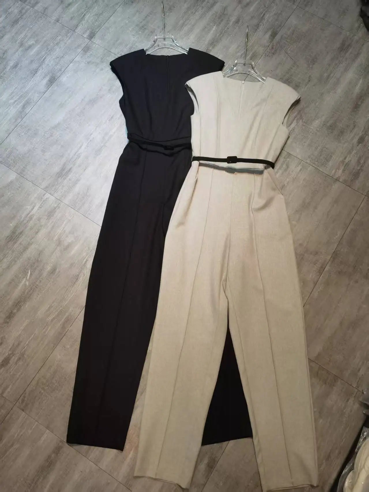 Elegant sleeveless trouser jumpsuit in a minimalist business style with belt