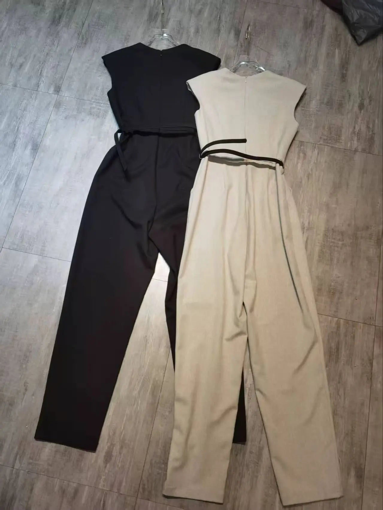 Elegant sleeveless trouser jumpsuit in a minimalist business style with belt