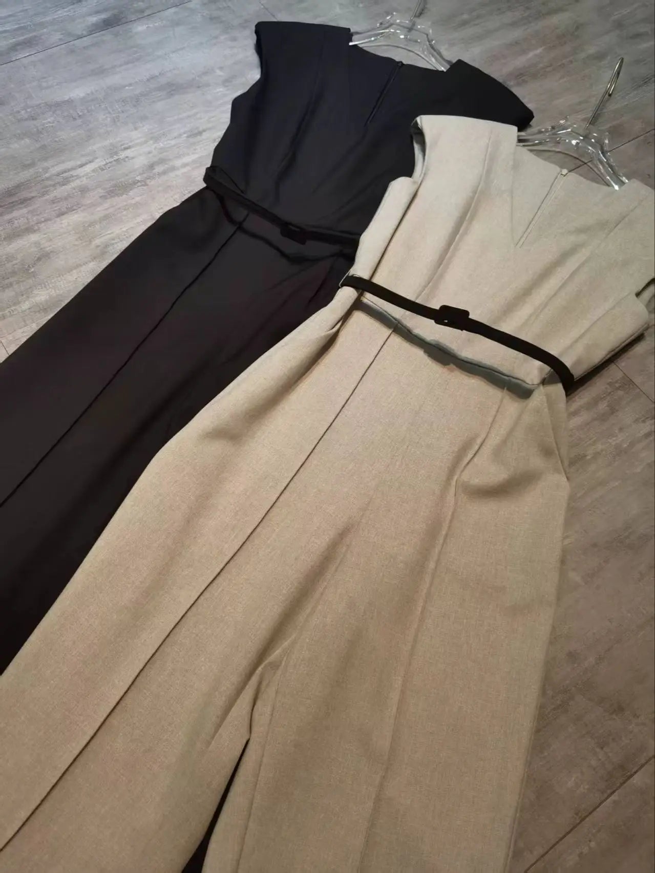 Elegant sleeveless trouser jumpsuit in a minimalist business style with belt