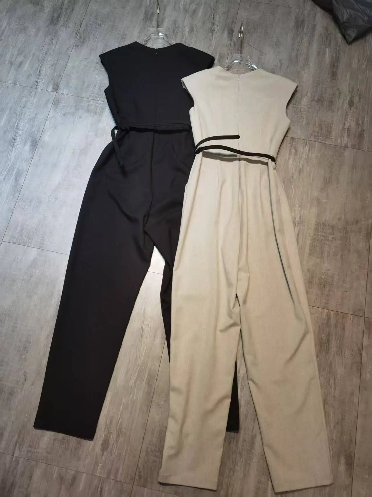 Elegant sleeveless trouser jumpsuit in a minimalist business style with belt