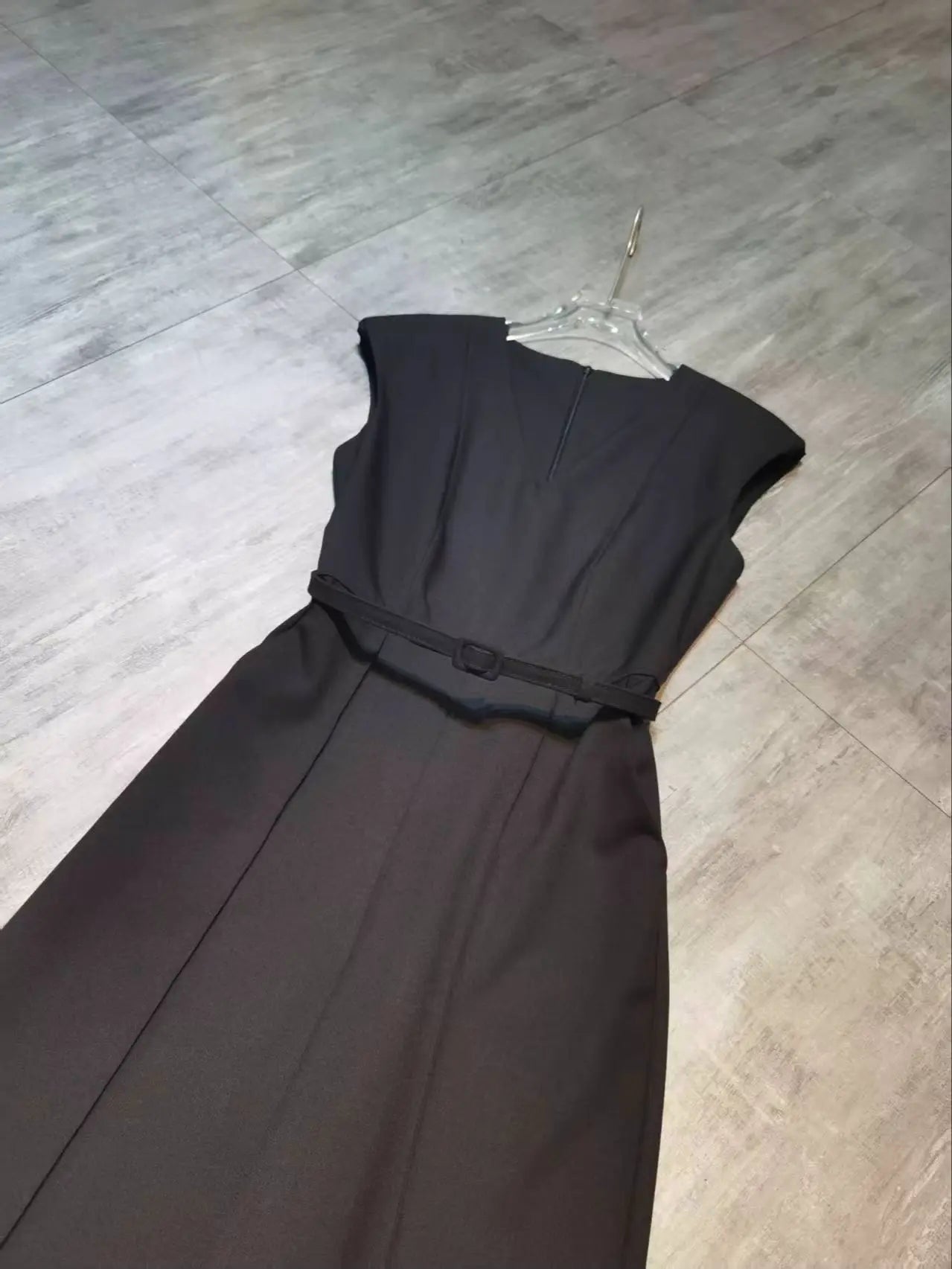 Elegant sleeveless trouser jumpsuit in a minimalist business style with belt