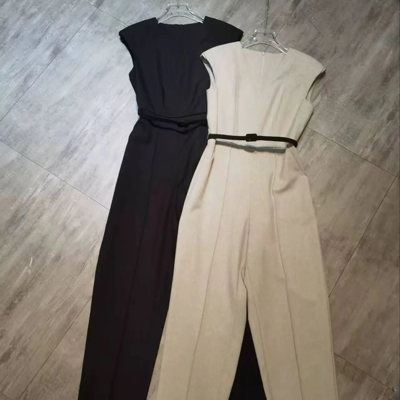 Elegant sleeveless trouser jumpsuit in a minimalist business style with belt