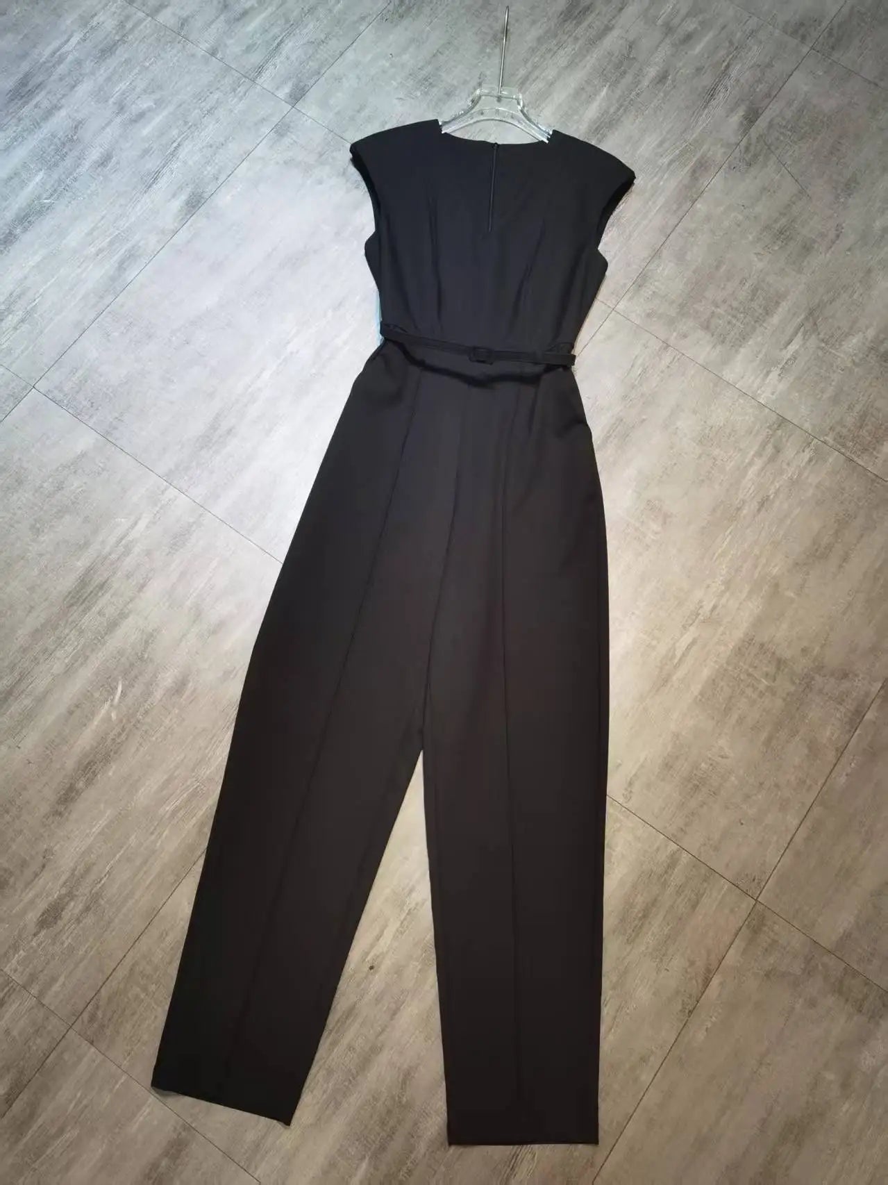 Elegant sleeveless trouser jumpsuit in a minimalist business style with belt