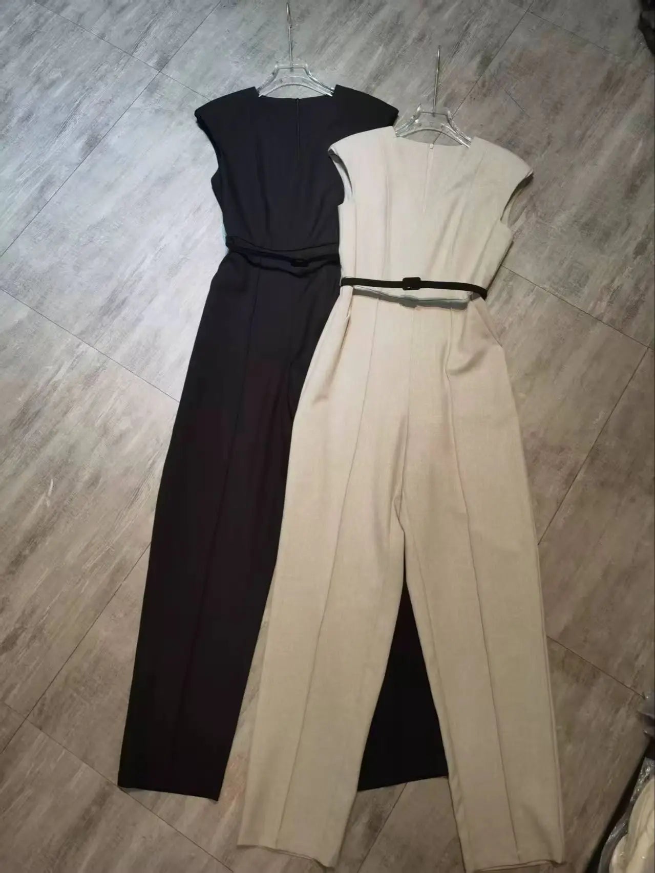 Elegant sleeveless trouser jumpsuit in a minimalist business style with belt