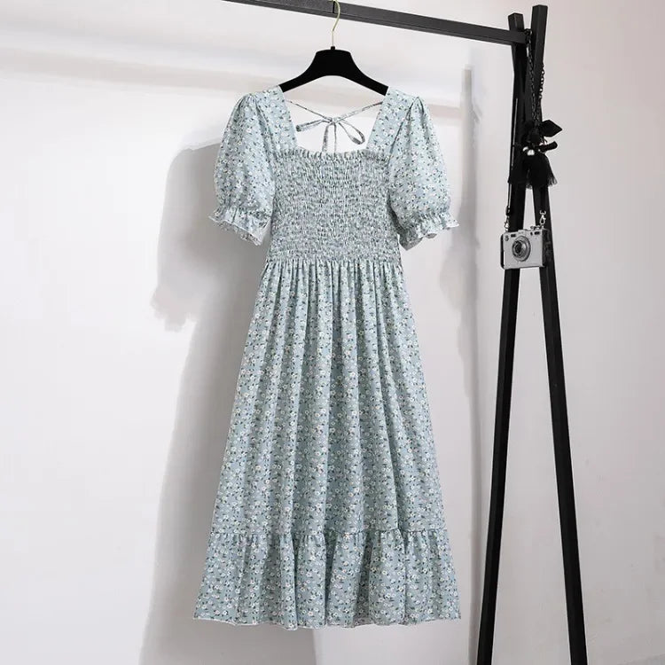 Dress, blue floral chiffon with smocked elastic waist, short puff sleeves, tiered A-line midi hem.