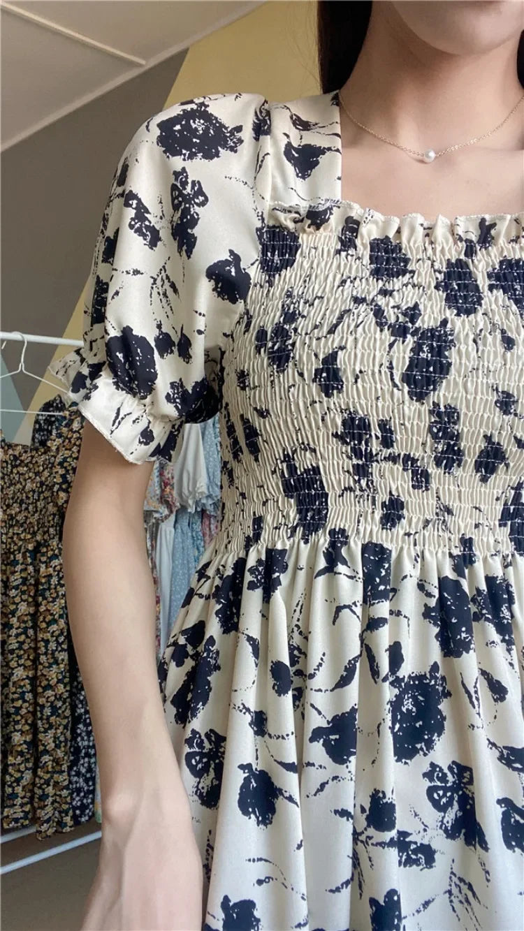 Chiffon dress with elastic waist in cream and navy abstract floral print; short puff sleeves