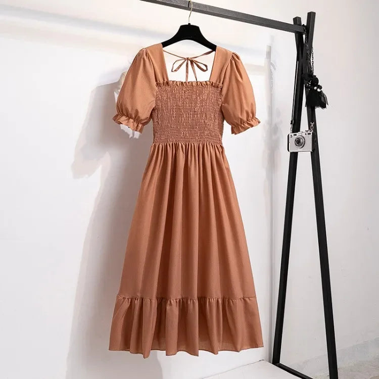 Women's brown chiffon dress with elastic shirred waist, short puff sleeves, A-line tiered hem.
