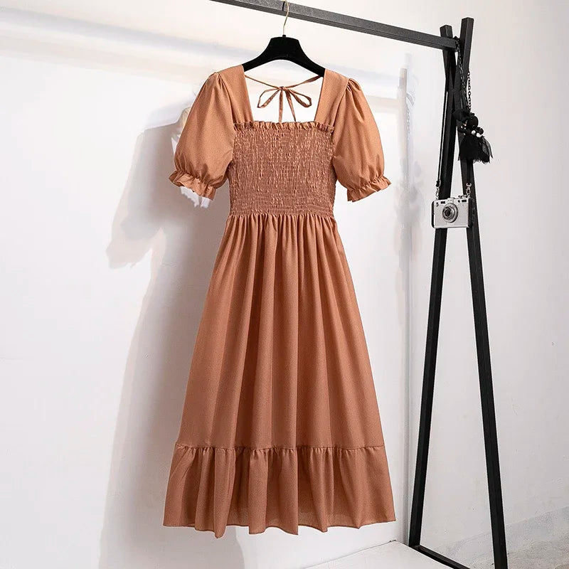Women's peach chiffon maxi dress with smocked bodice, elastic waist, puff short sleeves, and a ruffled hem