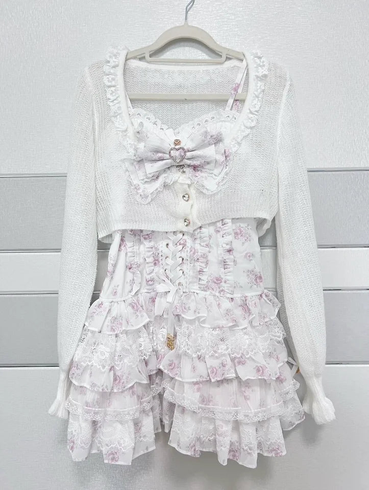 Two-piece white Japanese Sweet Lolita outfit: knit cardigan with lace trim and bow, plus tiered floral lace mini skirt.