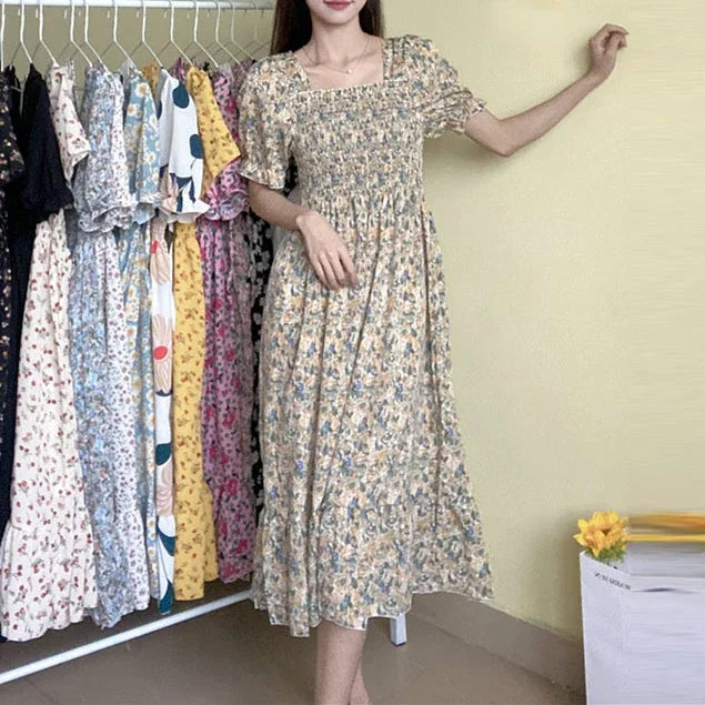 Women's floral chiffon dress with elastic waist, short sleeves, A-line silhouette; beige with blue flowers.