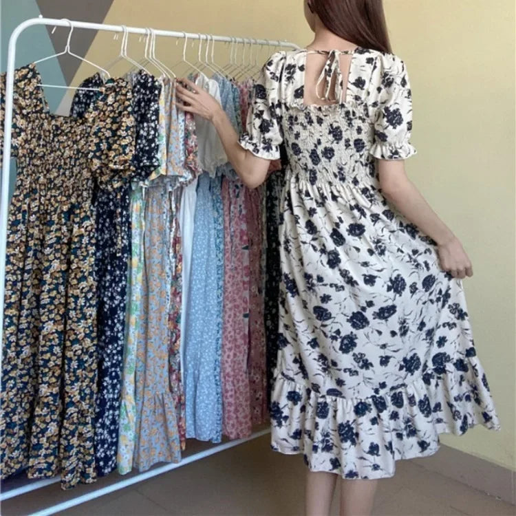 Women's floral chiffon dress with elastic waist, cream base and navy print; short sleeves, tiered A-line