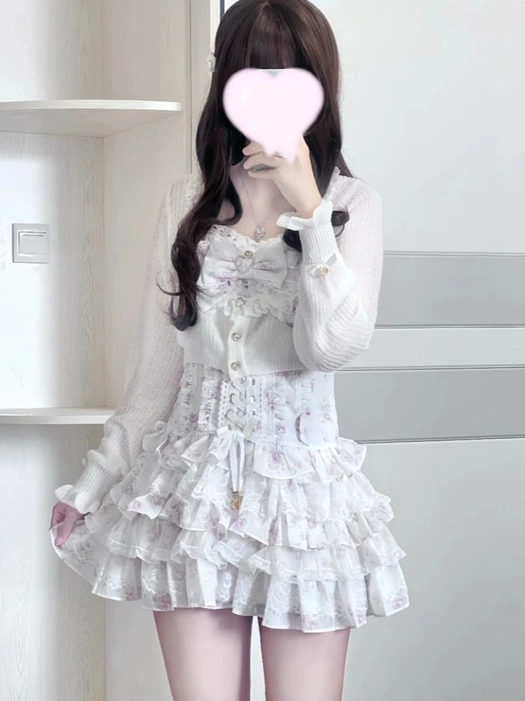 White two-piece Lolita lace floral print set with bow-accent long-sleeve cardigan and layered ruffle mini skirt