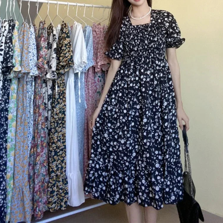 Women’s navy floral chiffon dress with short puff sleeves, elastic waist, and pleated A-line silhouette.